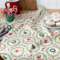 Cotton tea towel with a festive holiday design featuring Christmas trees, wreaths