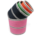 Four woven storage baskets in varying sizes and colours stacked