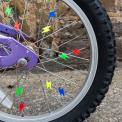 bicycle wheel with colourful lightning bolt-shaped spoke decorations