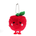Red apple-shaped plush wind-up toy with a smiling face