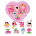Assorted colourful rings with animal, mermaid, flower, and fruit designs in a pink heart-shaped box