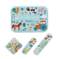 Farmyard-printed plasters placed beside a matching storage tin featuring farm animals illustrations