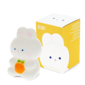 White bunny night light with an orange carrot, shown next to its yellow packaging box