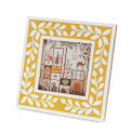Square picture frame with white leaf patterns and mustard yellow colour on the border.