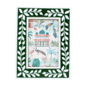 picture frame with a green border and white leaf patterns