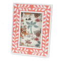 picture frame with a pink border and white leaf patterns
