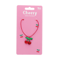 Children’s necklace with red cord and sparkling cherry pendant in packaging