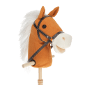 hobby horse toy with white mane and black bridle on a wooden stick