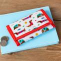 Wallet in white featuring colourful illustrations of sausage dog wearing striped jumper
