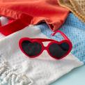 Heart-shaped funglasses with red frames and dark lenses