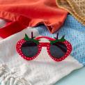Red strawberry-shaped funglasses with green leaves, and dark round lenses