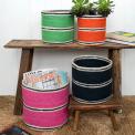 Four woven storage baskets in varying sizes and colours