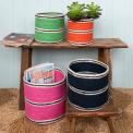 Four woven storage baskets in varying sizes and colours