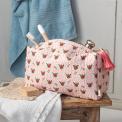 Rectangular makeup bag in pale pink with a floral pattern of small red and green flowers