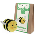 Crochet kit packaging and finished crocheted bee beside it