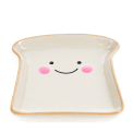 Ceramic trinket dish shaped like a slice of bread with a smiling face and pink cheeks