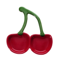 Red ceramic trinket dish shaped like two cherries with green stems.