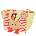Yellow handbag with red polka dots and a cartoon apple design with two red feet at the bottom with tag