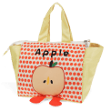 Yellow handbag with red polka dots and a cartoon apple design with two red feet at the bottom