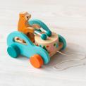 Wooden pull-along toy featuring a bear playing a drum, with colorful wheels