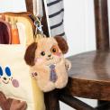 dog-shaped plush keyring wearing a tie with brown ears 