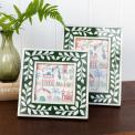picture frame with a green border and white leaf patterns