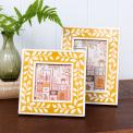 picture frame with a mustard yellow border and white leaf patterns
