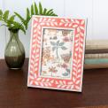 picture frame with a pink border and white leaf patterns