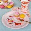 Pink unicorn-themed paper plate displayed with macarons and matching cup and napkin.