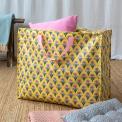 Yellow jumbo storage bag with a pink floral pattern and pink handles.