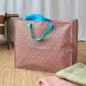 Pink jumbo storage bag with colourful floral designs.