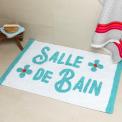 A tufted bath mat in blue and teal with the word “Salle De Bain” on the surface.