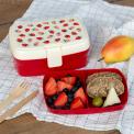A strawberry‑themed lunch box with an inner tray containing food.