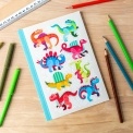Notebook with colourful dinosaurs on a light background.