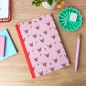 Pink notebook with a french rose design on the cover.
