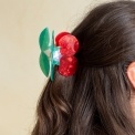 Hair claw clip featuring a sweet cherry design in red, green and white, with hints of marbling and translucence. 