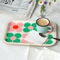 Wooden tray with pink and green daisy design, shown with a mug, spoon and napkin.