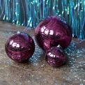 Plum hanging disco ball ornament with mirrored tiles shown in different sizes.
