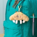 Fluffy croissant bag charm with smiley face, cheese patch and clip attachment