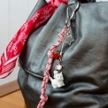 Pink keyring bag charm with a metal clip, decorated with a white dog and red strawberry.