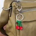 Cherry keyring with green stems and silver ring and clip attachment.
