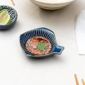 Fish-shaped blue ceramic dipping bowl shown with dipping sauce.