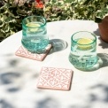 Set of two ceramic drinks coasters featuring an elegant embossed pattern, reminiscent of traditional tile designs.