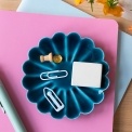 Blue enamel flower-shaped trinket dish holding clips and small items