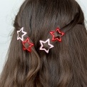 Red and pink star hair clips in a set of four.