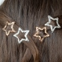 Silver and gold glitter star hair clips in a set of four.