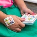 Dinosaur plasters in tin with individual plasters shown.
