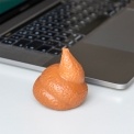 Poo-shaped squishy stress toy on a desk