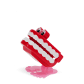 Wind-up toy shaped like red chattering teeth with white teeth, googly eyes, and pink feet
