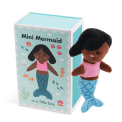 Mini mermaid soft toy placed beside a small illustrated box with mermaid design